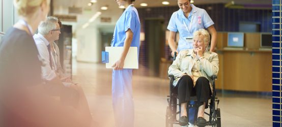 Healthcare-worker-pushing-patient.jpg