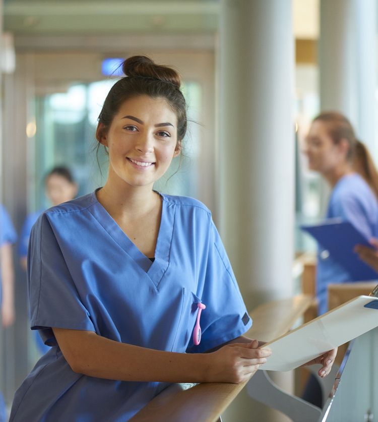 istock nurse standing with clipboard.jpg